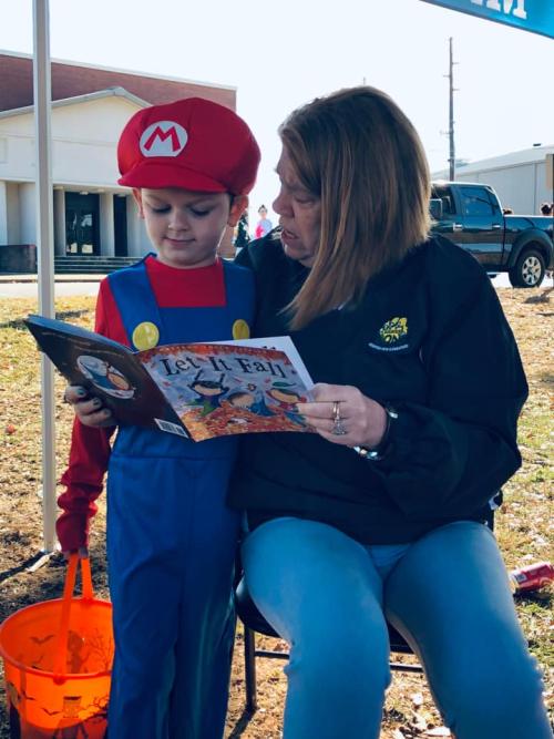 Reading a Book to a Studnet at Trunk or Treat Event in Manchester.jpg