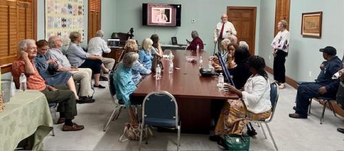 Group picture of Bob Patterson speaking to attendees at the Centential event.jpg