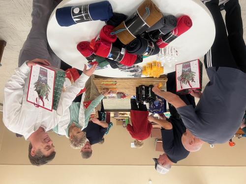 Rotarians and Manchester Kiwanis Club in action putting together Christmas bags for Seniors 2024.jpg