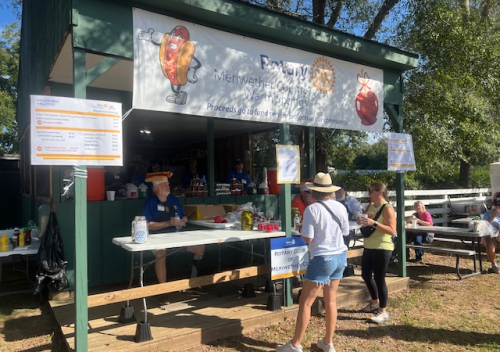 Front of Rotary Booth with Bob Patterson selling hotdogs.png