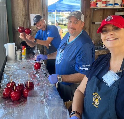 Tab Blackburn, Dist Gov Gordon Owens and Deanne Crews making candy apples 1.png