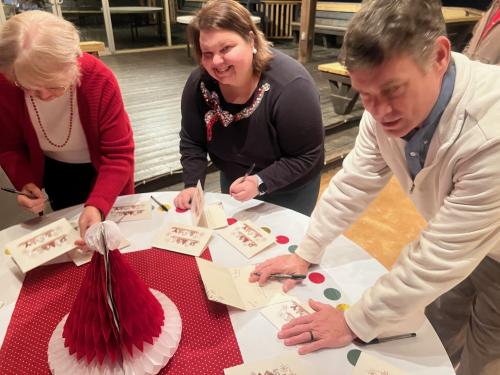 Wanda, Melissa and Cole signing cards.jpg