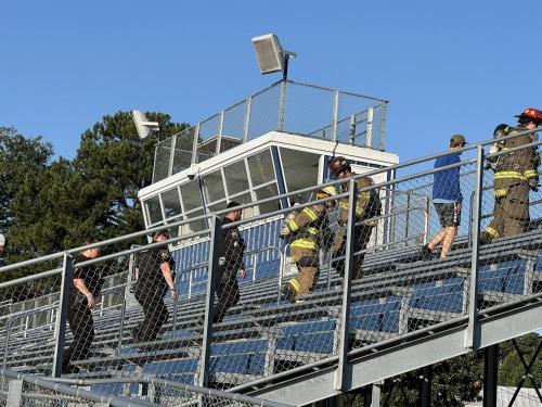 Responders climb the stadium stairs at MHS in rememberance of 911.jpg